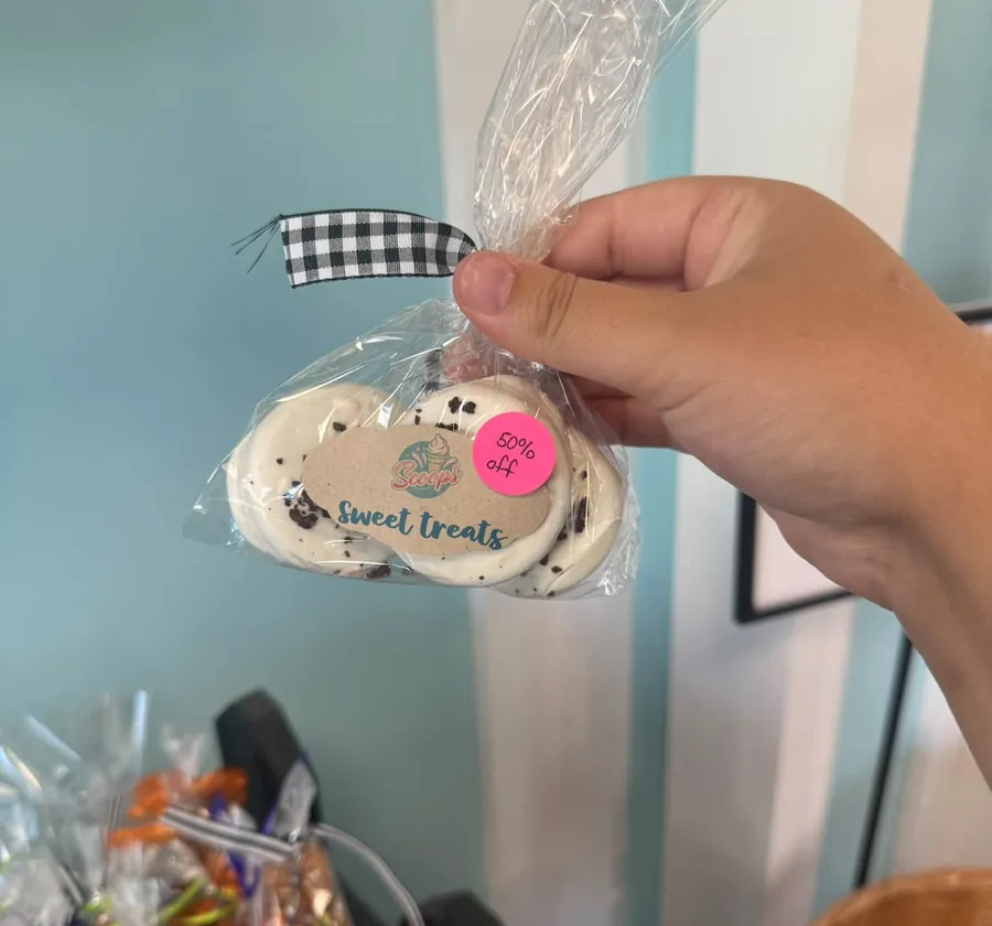 A bag of chocolate-dipped Oreos with a Sweet Treats tag